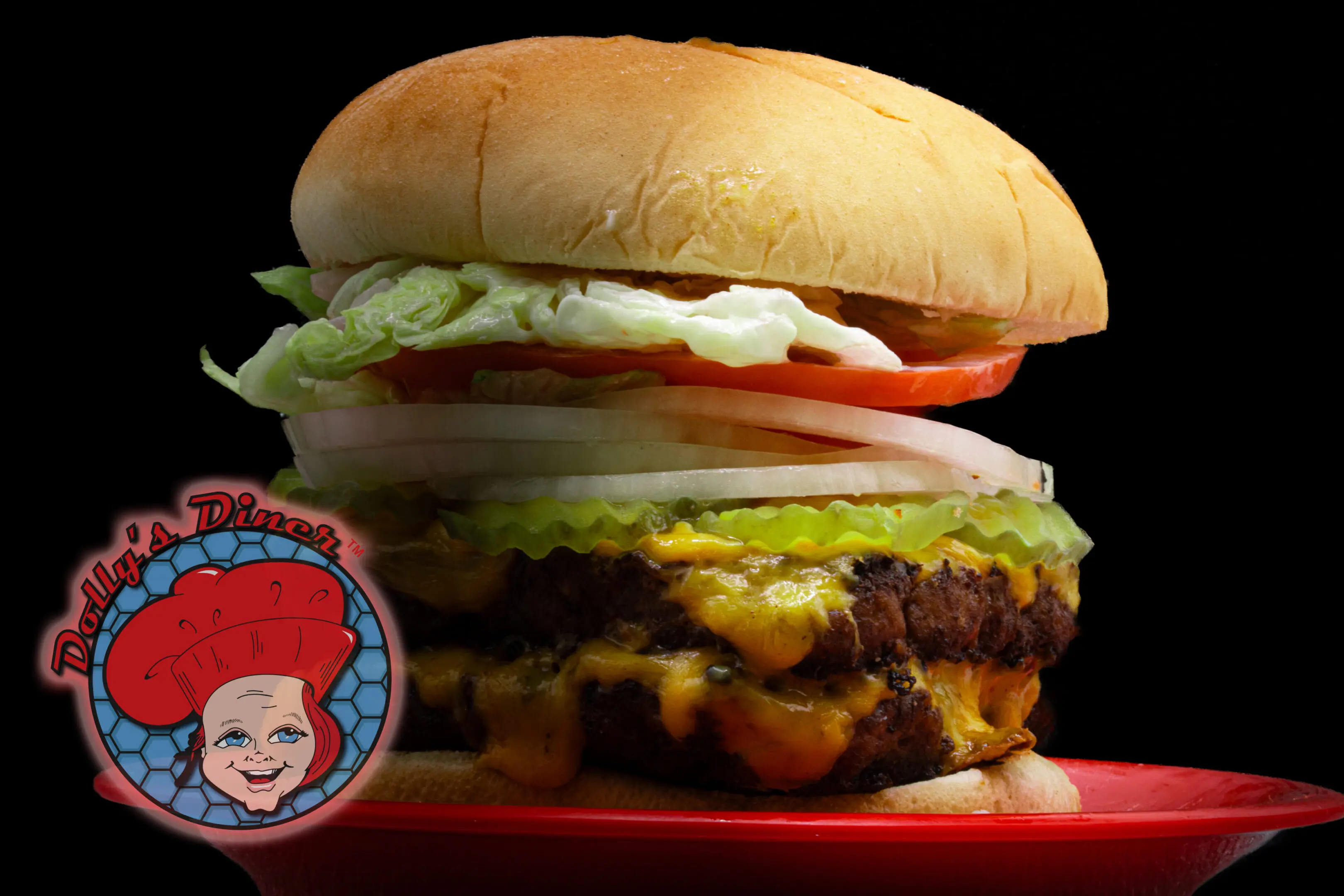 Cheeseburger with lettuce, tomato, and onions.