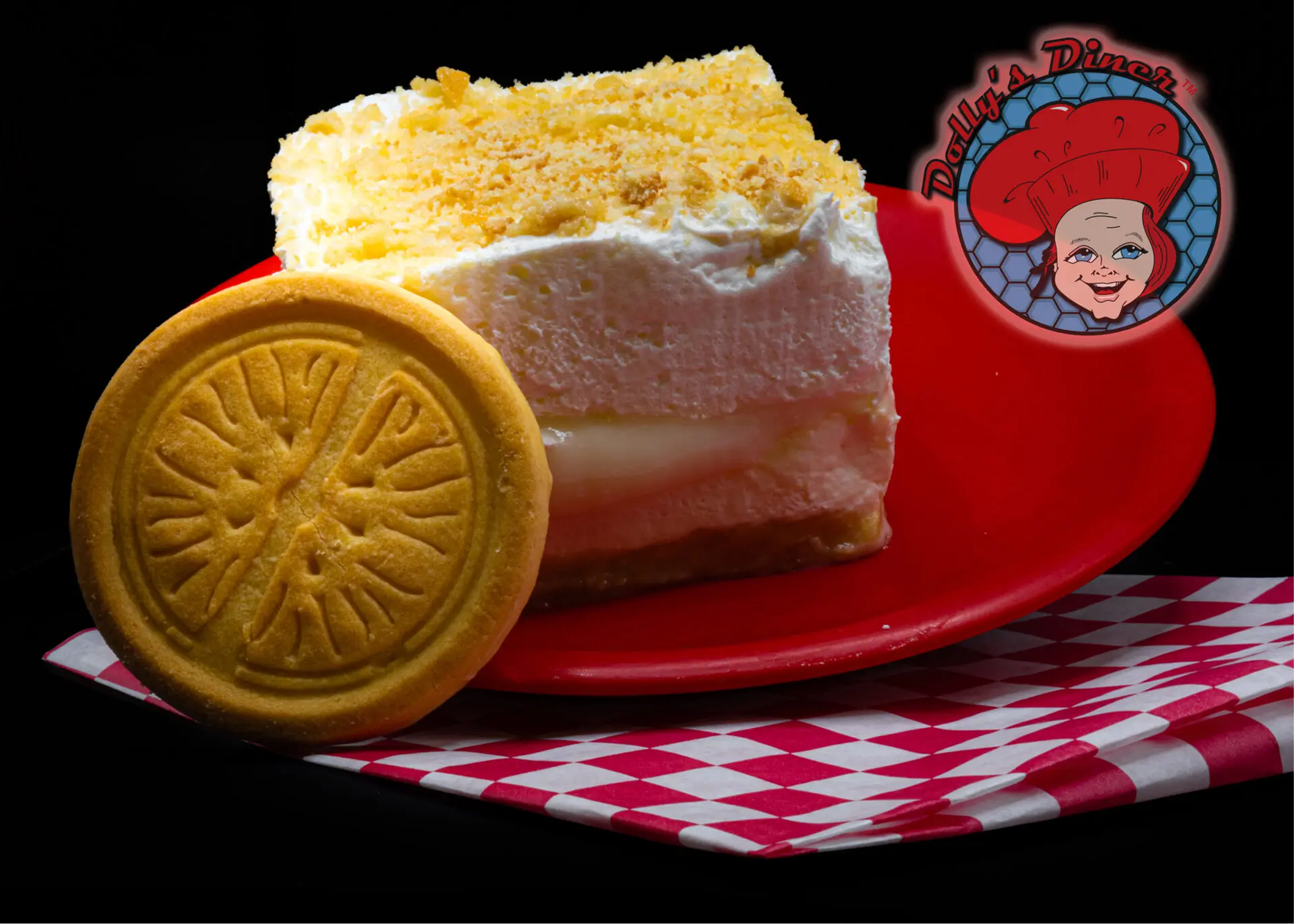 Cake and cookie on red plate, checkered napkin.