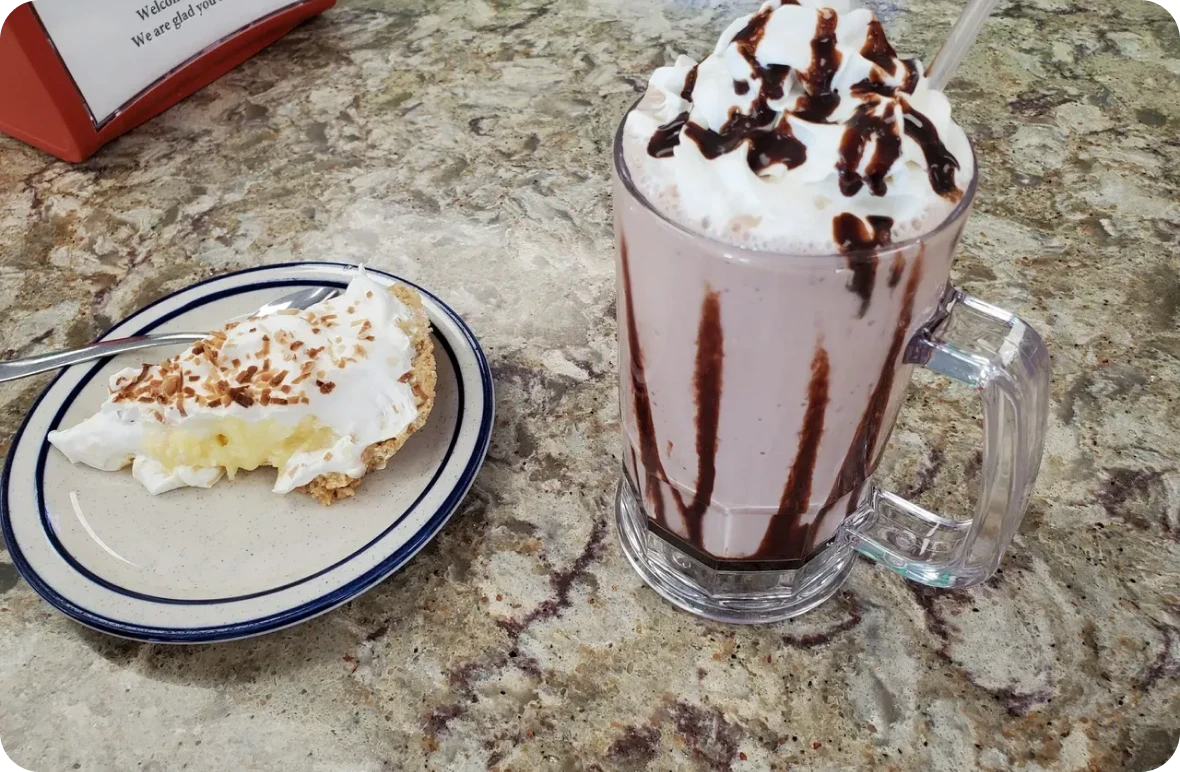 Milkshake with whipped cream and pie slice
