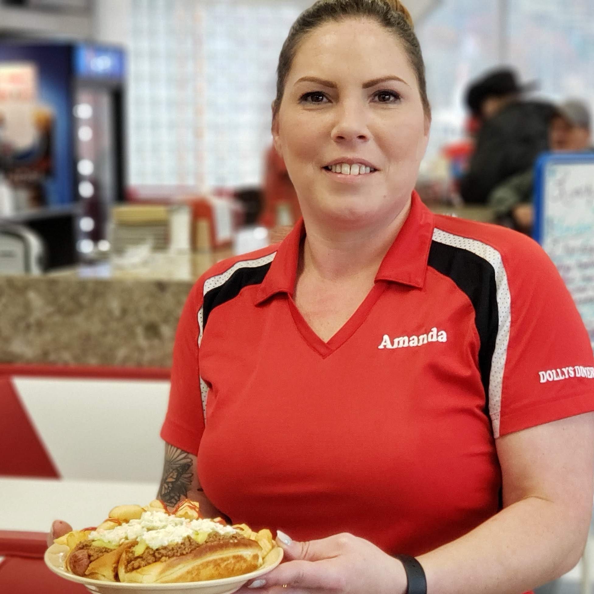 Server holding a plate with food.